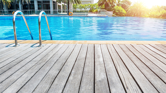 Swimming pool with stair and wooden deck.