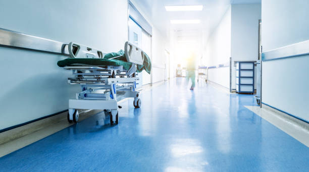 Doctors or nurses walking in hospital hallway, blurred motion Doctors or nurses walking in hospital hallway, blurred motion. hospital emergency sign stock pictures, royalty-free photos & images