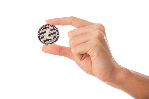 Teenager hand holding crypto coin on cut out white background.
Litecoin is a peer-to-peer cryptocurrency and open-source software project released under the MIT/X11 license. Litecoin was an early bitcoin spinoff or altcoin, starting in October 2011. In technical details, Litecoin is nearly identical to Bitcoin.