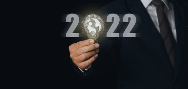istock Businessman holding light bulb with virtual Global Internet connection 2022 and metaverse. 1386602002