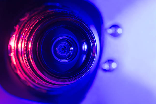 istock Camera lens with purple and pink backlight. Optics. Cyberpunk style 1386605372
