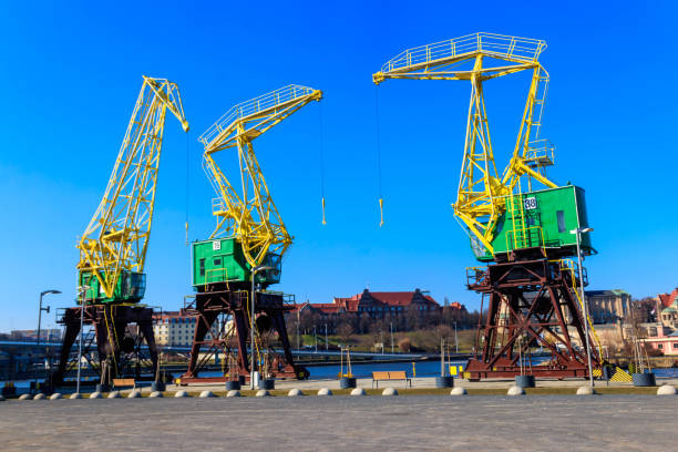 istock Old cranes on city boulevard in Szczecin, Poland 1386608628