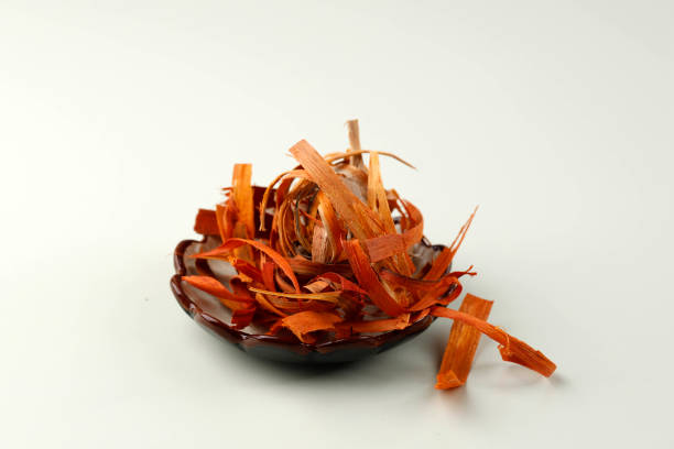 Caesalpinia sappan or Kayu Secang (Indonesia) on Cream Table. Traditional Herb Medicine Alternative Ingredients. Isolated
