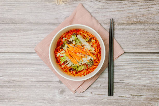 jjolmyeon fait référence aux nouilles épaisses à la farine caractérisées par leur moelleuse. il est généralement garni de concombre, de chou et de germe de haricot et mélangé à une sauce gochujang (pâte de piment rouge) à la table. - prepared shrimp skewer rice prepared fish photos et images de collection