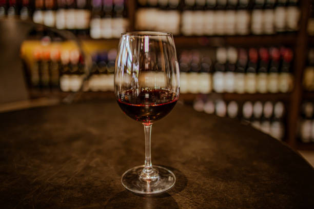 istock Glass of red wine on table 1386612805