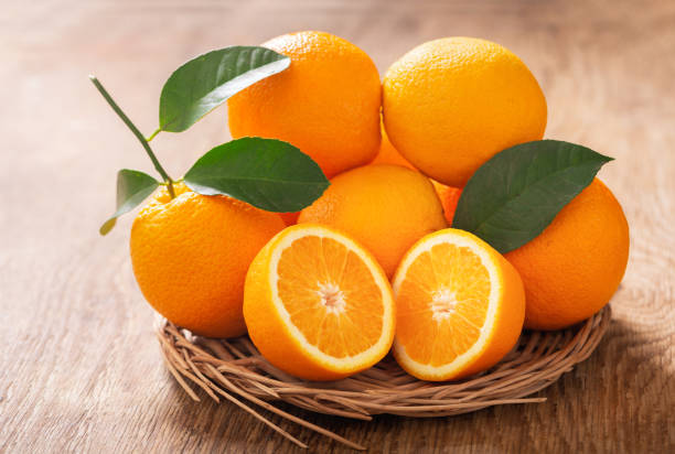 istock fresh orange fruits on wooden table 1386612832
