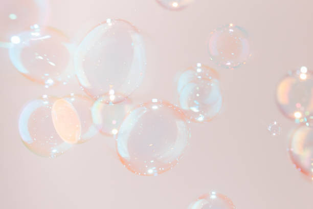 istock Beautiful Shiny Pink Transparent Soap Bubbles Flaoting in the Air. 1386613652