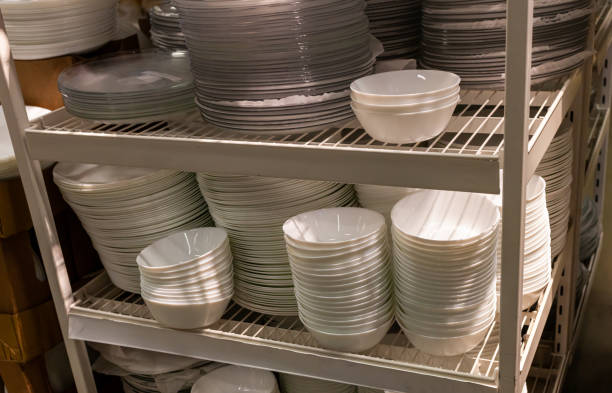 istock Shelves are lined with multi-colored plates and china bowls. Decorative cutlery. 1386614748