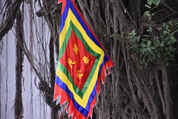 istock Colorful Buddhist Flag on Banyan Tree 1386616930