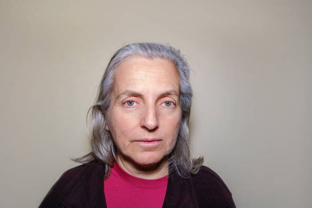 istock Elderly woman looking at camera with thoughtful, hurt expression 1386621322