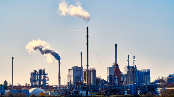 istock Small refinery with smoking chimneys and many storage tanks for liquids 1386621363