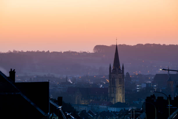 Long street down whit a view of Sint-Hermesbasiliek whit sunrise.