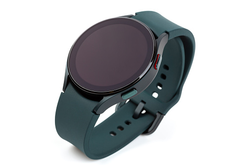 Smart watch with black screen and green silicone band isolated on white background