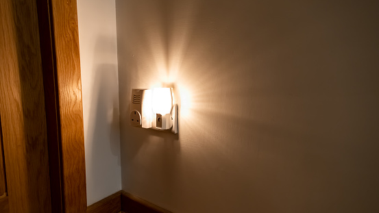 Night light plugged into a wall in a house