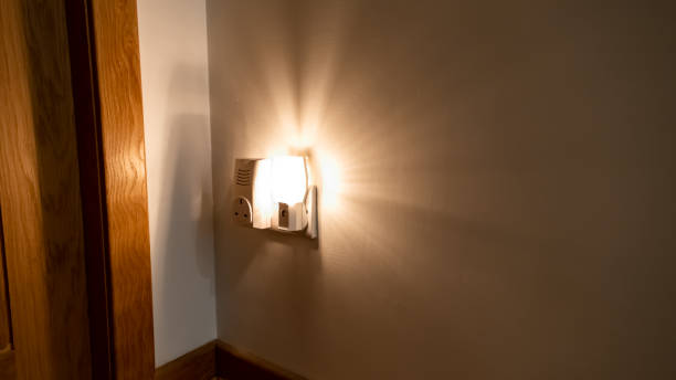 Night light plugged into a wall in a house stock photo