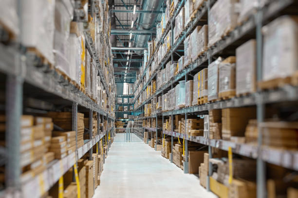 istock Generic warehouse interior with high shelves and boxes of products 1386635940