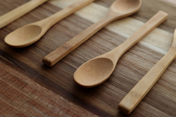 istock Wooden teaspoons lie on a wooden background. 1386635954