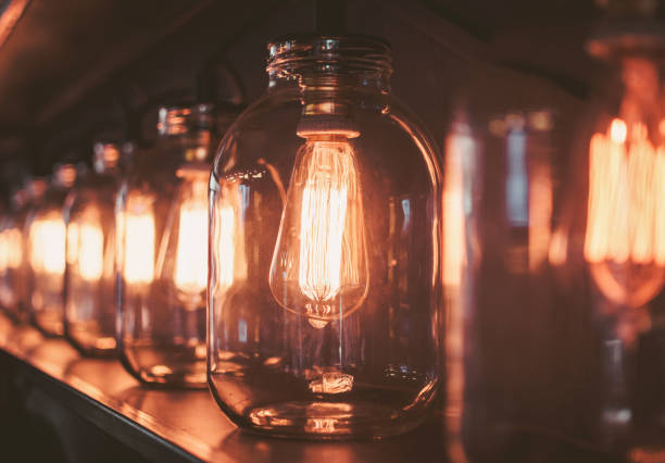 istock Row of light bulbs inside glass cans 1386636984