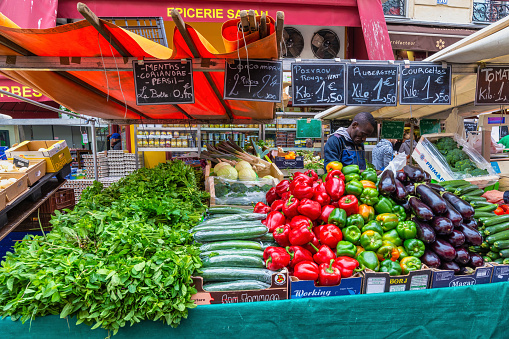 Paris, France - May 4, 2017: fresh vegetable retail shop at Aligre Market in Paris