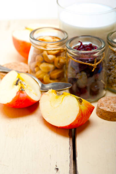 healthy breakfast ingredients milk oat cashew nuts dried cramberry craisinns