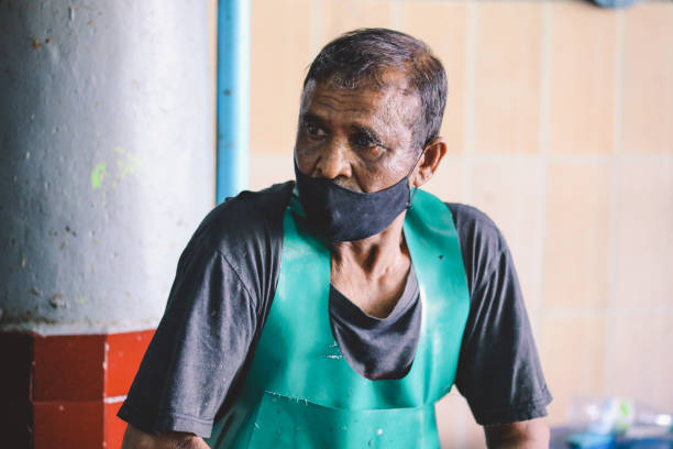 Local Maldivian Fisherman Working on the Central Market of Male City Male, Maldives - June 25, 2021: Local Maldivian Fisherman Working on the Central Market of Male City maldives fish market photos stock pictures, royalty-free photos & images