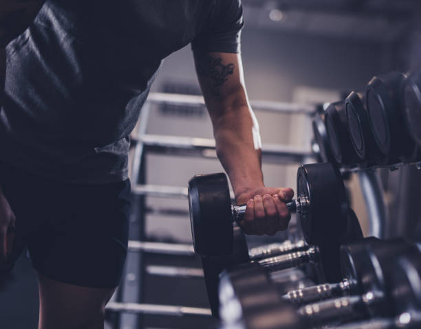 istock Close-up of man's hands taking dumbbell 1386642594