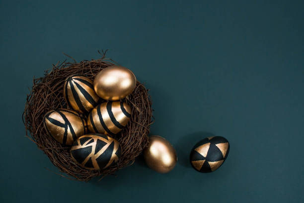istock Gold, black, white eggs on a trendy emerald background. Geometry. The minimal concept. Top view. An Easter card with a copy of the place for the text. 1386644384