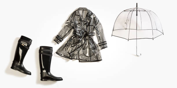 Fashionable black rain boot,  transparent raincoat with umbrella