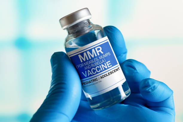 Doctor with vial of the doses vaccine for MMR Measless, Mumps and Rubella diseases. Medicine and health care concept Vaccination for booster shot for MMR Measless, Mumps and Rubella diseases in the children and adolescents. Doctor with vial of the doses vaccine for MMR Measless, Mumps and Rubella diseases measles stock pictures, royalty-free photos & images