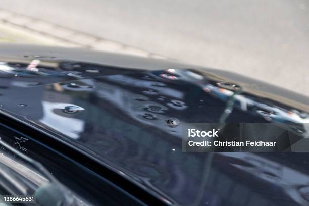 Car Engine Hood With Many Hail Damage Dents Show The Forces Of Nature And The Importance Of Car Insurance And A Replacement Value Insurance Against Stormy Weather And Storm Hazards Or Extreme Weather Stock Photo - Download Image Now