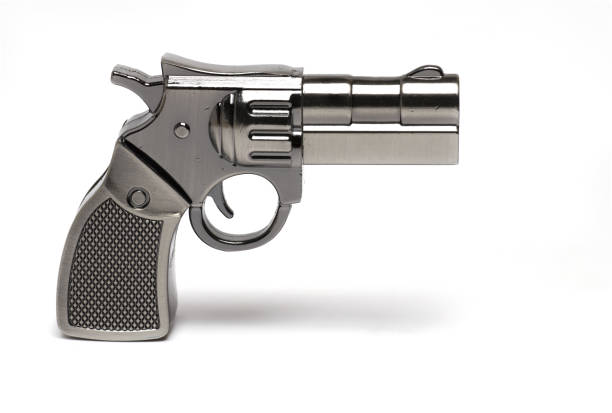 istock Closeup toy gun revolver shadow white background 1386647906