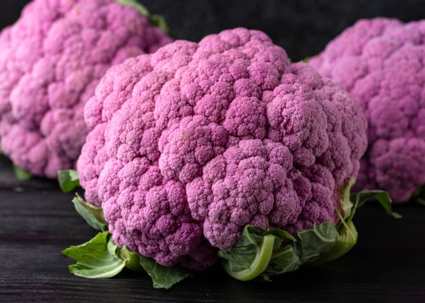 Purple colourful cauliflower on black wooden table