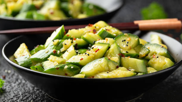 istock Smashed cucumber spicy Asian style salad with soy sauce dressing, chilli flakes, garlic and sesame seeds 1386648896