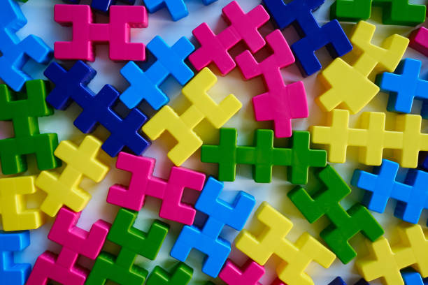 istock Colored puzzles on a light background. Logic games constructor for children and adults. Bright background and texture 1386659281