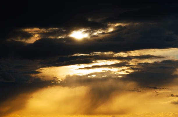 istock beautiful dramatic sunset sky, bright sunlight and dark silhouette of clouds as background 1386666566