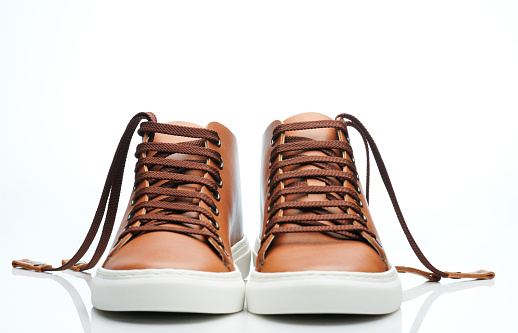 Front view of brown leather shoes. isolated on studio background