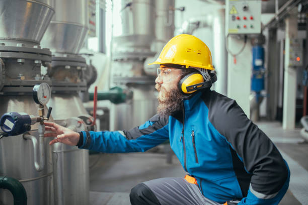 istock A man with a yellow hardhat and antiphons in a natural gas processing plant. 1386670570