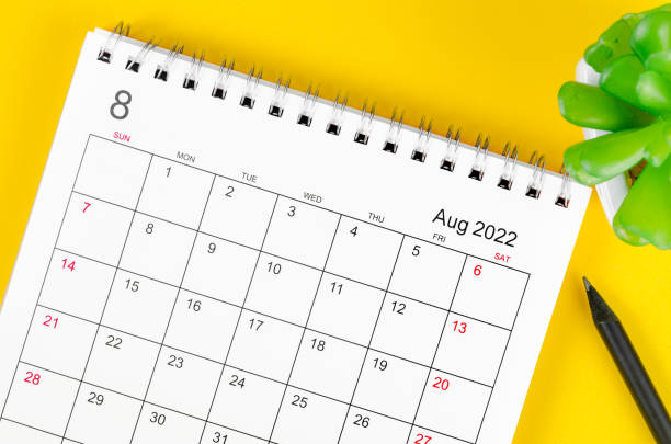 istock August 2022 desk calendar on yellow background. 1386672067