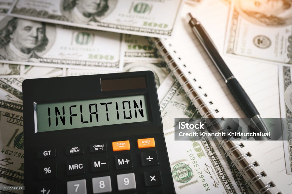 INFLATION word on calculator in idea for FED consider interest rate hike, world economics and inflation control, US dollar inflation Inflation - Economics Stock Photo