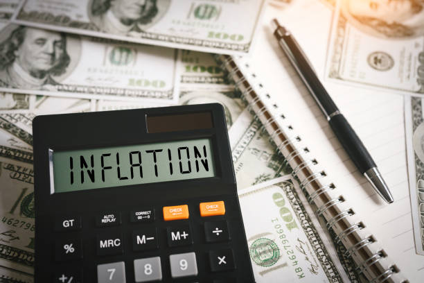 inflation word on calculator in idea for fed consider interest rate hike, world economics and inflation control, us dollar inflation - us paper currency fotos imagens e fotografias de stock