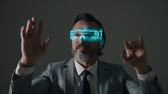 Mature businessman with augmanted reality glasses.