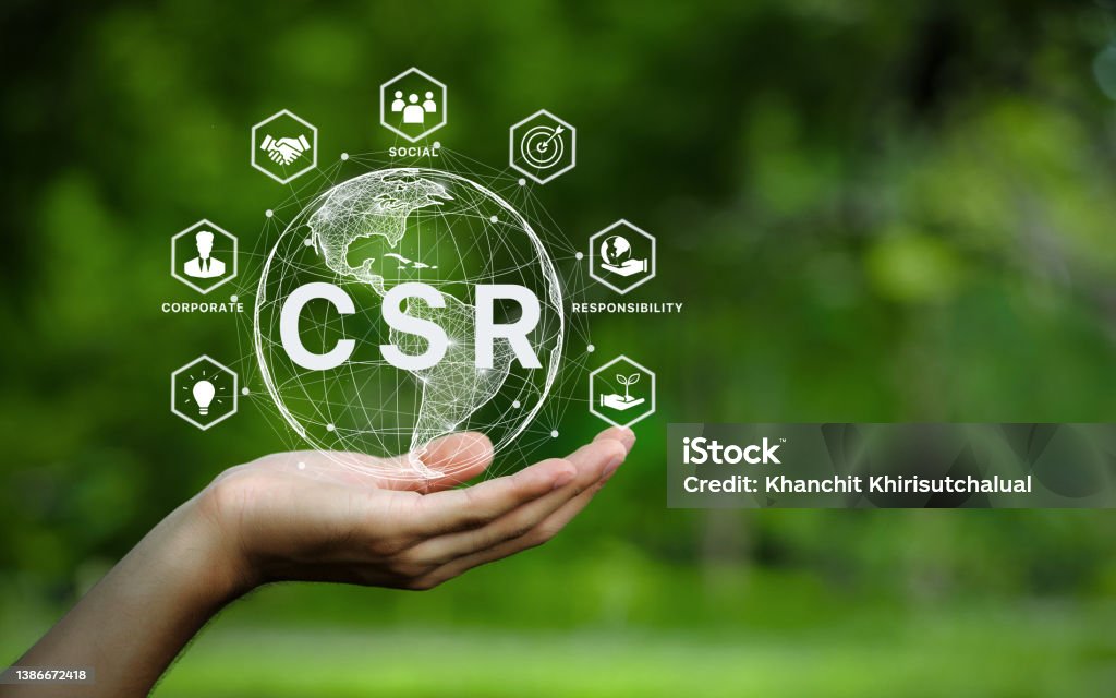CSR icon concept in the hand for business and organization, Corporate social responsibility and giving back to the community on a green nature background. Responsibility Stock Photo