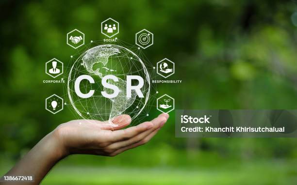 Csr Icon Concept In The Hand For Business And Organization Corporate Social Responsibility And Giving Back To The Community On A Green Nature Background Stock Photo - Download Image Now