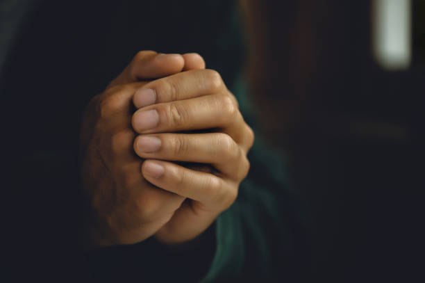Man worship pray for god blessing to wishing have a better life. Man hands holding praying to god with the bible. christian life crisis prayer to god concept stock photo