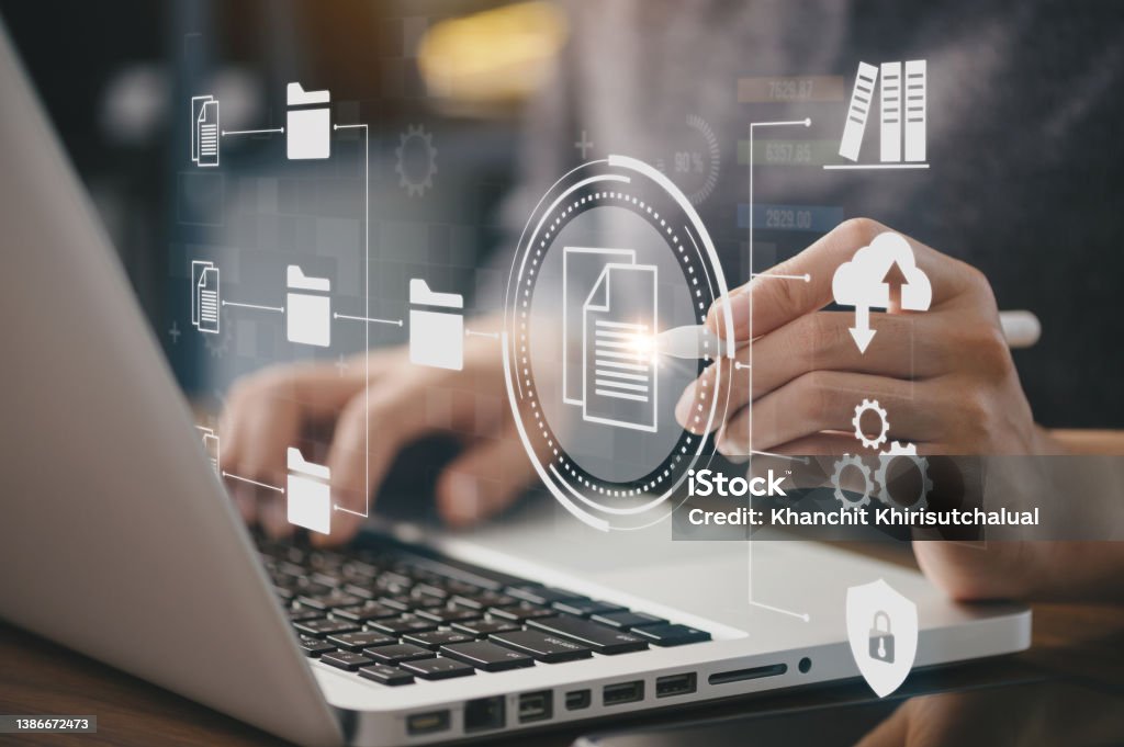 Businessman using a computer to document management concept, online documentation database and digital file storage system or software, records keeping, database technology, file access, doc sharing. Organization Stock Photo