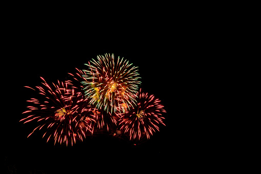 Fireworks on the beach. New year celebration on the beach crowded with people. Santos city, Brazil.