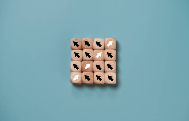 istock Disruption and technology transformation concept , White arrow on wooden block cube move  in opposite direction from black arrow on blue background. 1386682109