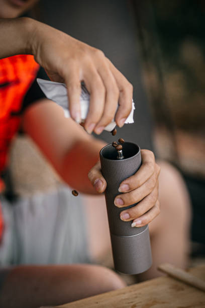 asian barista is using a manual coffee maker aeropress to make coffee - coffee bean bag human hand imagens e fotografias de stock