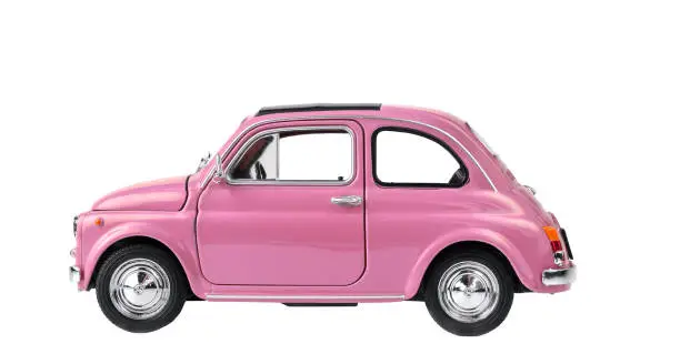 Photo of Pink retro toy car isolated on white