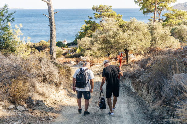 Senior father and his young son going to sea side for fishing